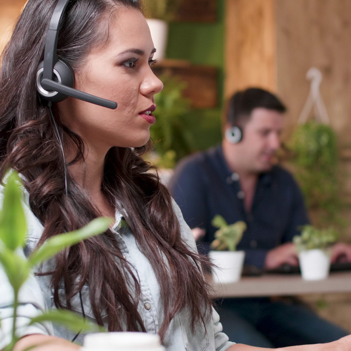 Call routing miami Young support customer woman talking into headset microphone with call center customer while working in startup company office. Caucasian female consultant providing telemarketing service