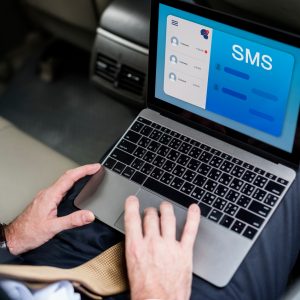 Communication Connection Message Networking A person checking their SMS trough their computer