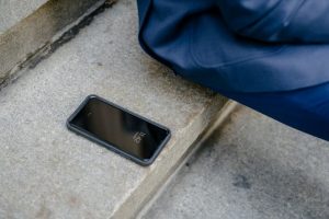 A phone out of their owner's pocket 